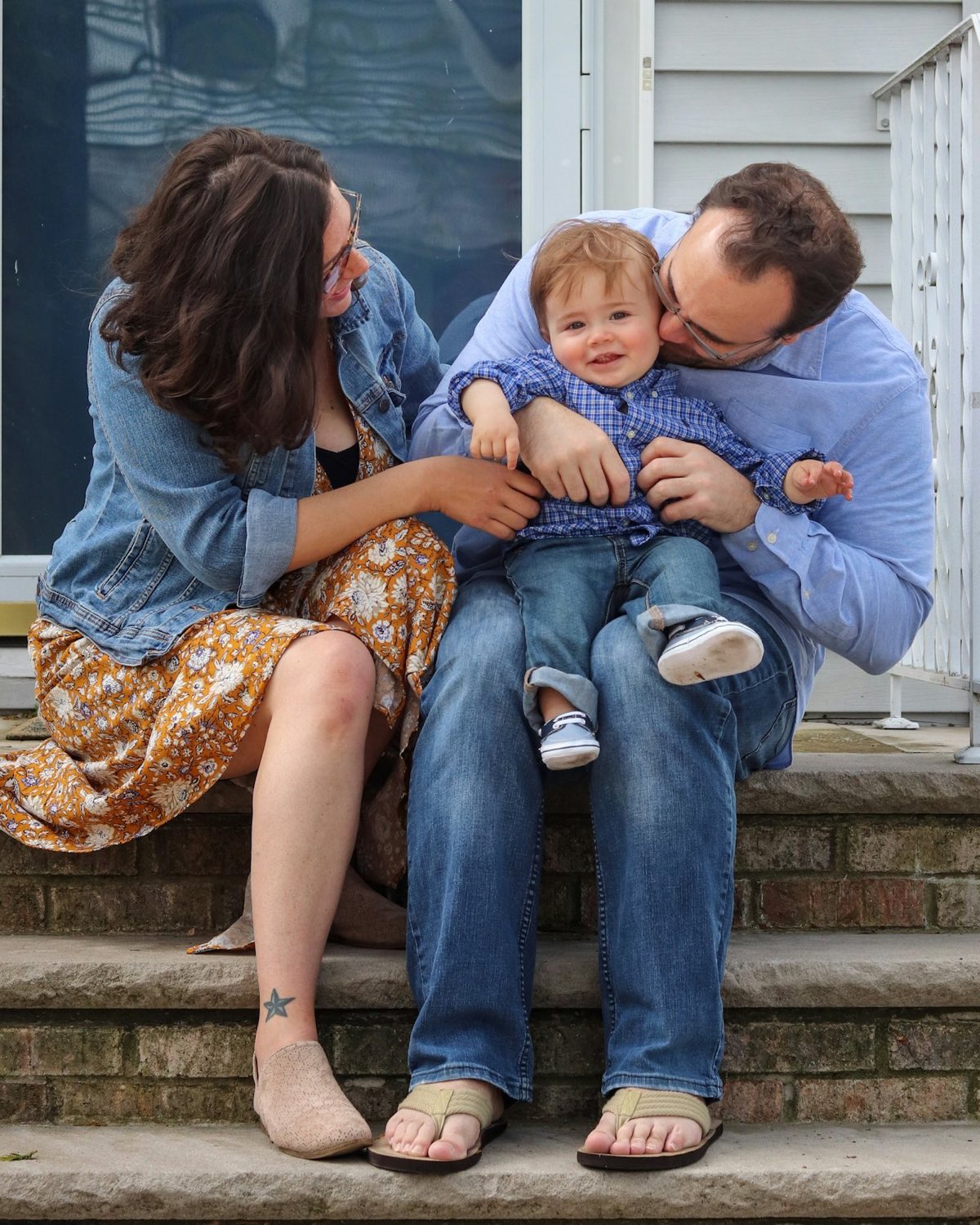 A family sharing a warm moment at the steps of a home — residential advisory